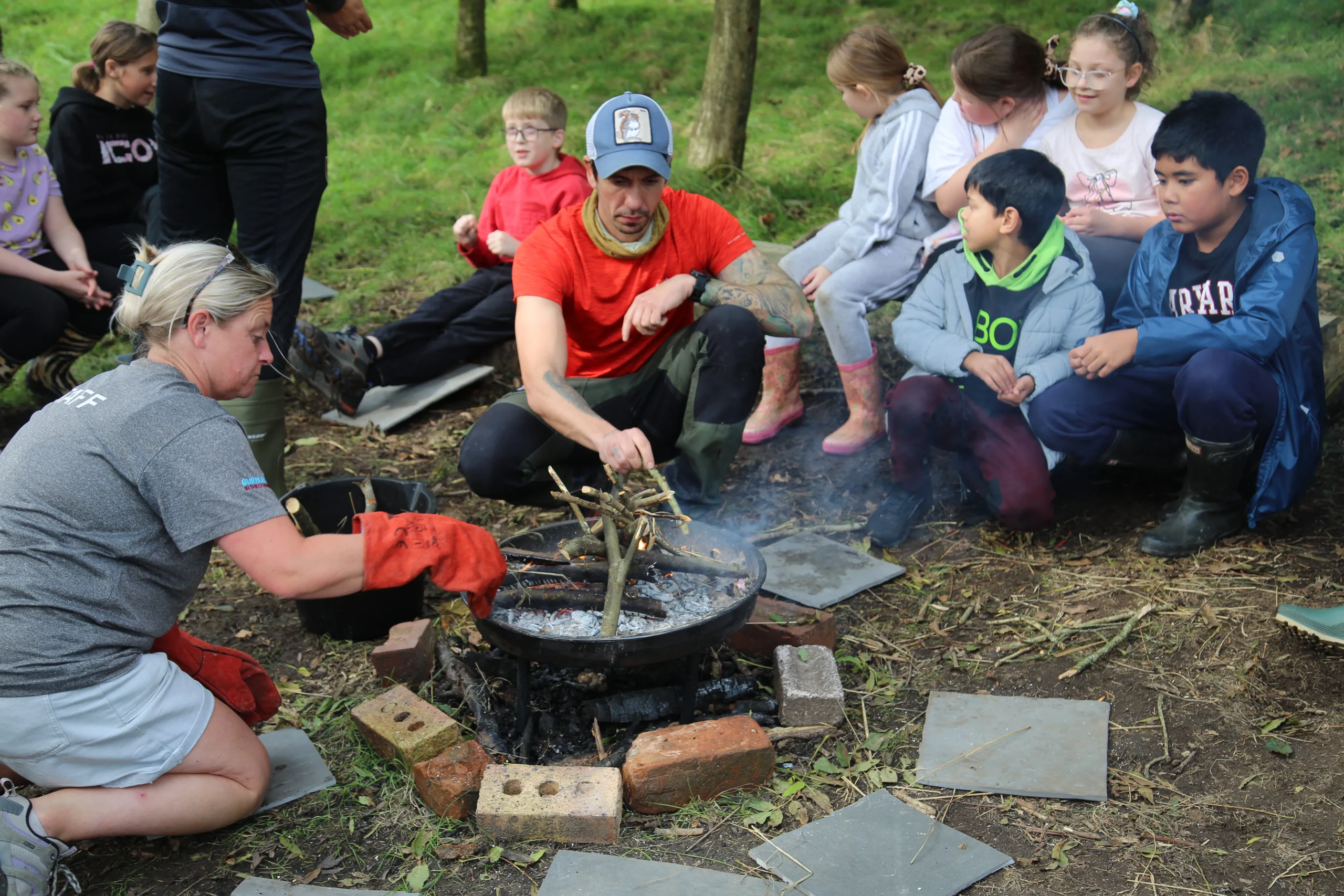 Primary school children around a fire pit bushcraft